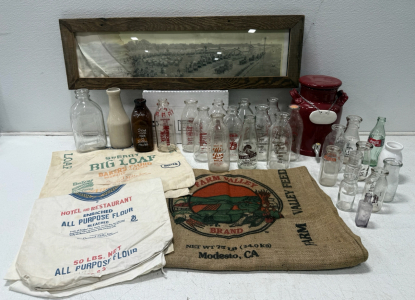 (4) Vintage Flour And Burlap Sacks (1) Vintage Oregon Trail Framed Picture (26) Glass Milk Bottles (1) Ceramic Red Drink Dispenser