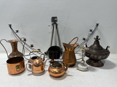 (1) Camera Tripod Unbranded (2) Candle Holders And Assorted Copper Tea Pots And Decor And (1) Black 32- Gallon Wheeled Trash Can