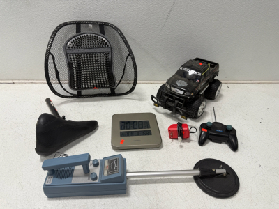 (1) 1960s Blue SELSI Co. Metal Detector Model No. 935 (1) Black Mesh Massage Car Waist Pillow, Lumbar Support (1) Ford F150 Harley Davidson Remote Control Truck (1) Black Bicycle Seat (1) Atomix Digital Clock