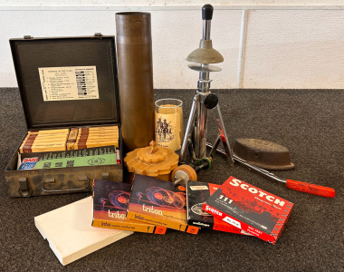 Box With Collectibles and Antiques: Brass Military Shell, First Aid Kit, Reel to Reel Tapes and More