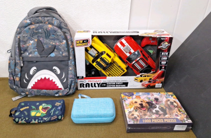 (1) Kids Shark Backpack, (1) Dinosaur Pen / Pencil Case, (1) Small Electronics Soft Case, (1) New Bright RC Car Set & (1) 1000-Piece Puzzle