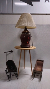 (1) 3-Legged Side Table, (1) Red Lamp w/Shade, & (2) Assorted Disigned Display Sleds