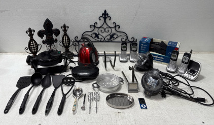 Assorted Kitchenware- Blue Apple Ipod- No Charger, Does Not Power On- DearFoam Mens Slippers Size M 9-10- (4) Uniden Home Phones - (2) Outdoor Yard Lights (1) Waffler Maker (1) Panini Press (1) Hamilton Beach Electric Tea Kettle And Much More
