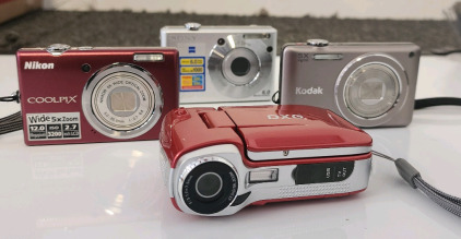 Nikon CoolPix Camera, Sony Cyber-Shot Camera, Kodak Easyshare Touch Camera, And A DXG Camera/Video Recorder.