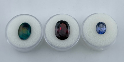 (1) 5.50ct. Natural Fire Opal Doublet Oval Shaped Ring Sized Cabochon (1) 11.15ct Pigeon Blood Red Ruby vvs Faceted Oval Cut Gemstone (1) 4.50ct Natural Blue Tanzanite Faceted Pear Cut Gemstone 8x10mm