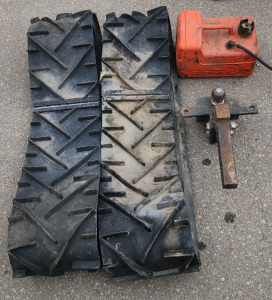 2 Sets Of Tracks, A Gas Can, And A Trailer Hitch