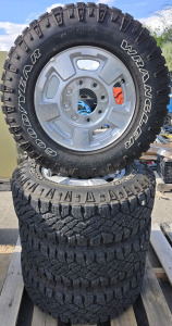 (4) Goodyear Wrangler Duratrac Tires w/ Chevrolet Wheels for Each & Hub Caps - LT245/75R17