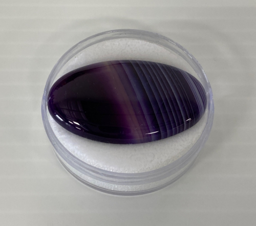 Consignor States Listing As Follows: 52.30 Ct Purple Striped Agate Cabochon