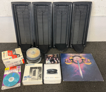 (4) CD Rack / Holders, DVDs Including Boston CD, Toto Record, Shade Auto Hub & Sanyo AM/FM Stereo Radio