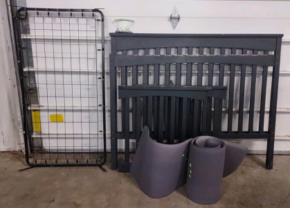 A Toddlers Black Bed Frame w/ Foam Floor Mats