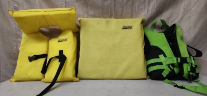 (2) Life Jackets Adult And Child Size, And A Throwable Floation Pad