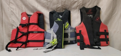 (2) Adult Small/Medium Life Jackets, And An Adult Universal Size Life Jacket.