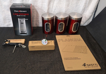 (1) Pohl & Schmitt Electric Can Opener, (1) Boomerang Bottle Opener, (1) Coffe & Milk Dial Thermometer, (1) 3-Piece Metal Container Set, (1) Skotti Plancha & (1) Box Of Assorted Amazon Overstock