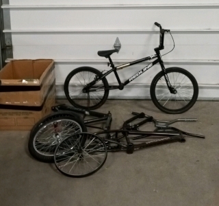 (1) Redline Black 20x1.75 Bike and (1) Assortment of Bike Parts and Tools