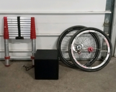 (1) Black Box Speaker, (2) Bicycle Wheels, and (1) Telescoping Ladder