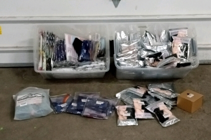 (1) Bin of Makeup Sponges and Makeup Products and (1) Bin of Decorative Flags