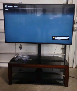 A 56&frac12;" Sony Flat Screen TV w/ Modern Style 3-Teir Glass Top TV Stand