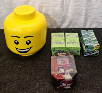 (1) LEGO Grinning Male Head - Stackable Storage Container - Large 10" x 9.25" & (2) 10/Fifteen Stick Packs Of Wrigley's DoubbleMint Gum, (1) Pack Of 9/Fifteen Piece Bottles Of Orbit White Spearmint Gum & (1) Pok&eacute;mon Cards Tin, Sealed W/Cards