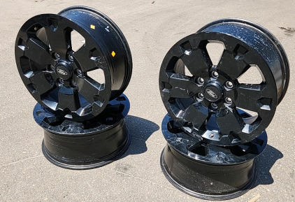 Ford 6 Hole Glossy Black Rims With Low pressure Indicators on Valve Stems