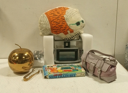 (1) Brand New Panasonic Car Stereo, (1) Brand New Purse, (1) Apple Container With Tongs, (1) Vintage Mickey Mouse Train Set, (1) Animal Pillow
