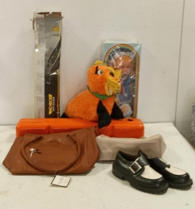 (1) Vintage Baby Caroll Doll, (2) Purses, (1) Pair of Size 7 Women's Shoes, (1) Vintage Walrus Plush, and (1) Monroe Magnum Part