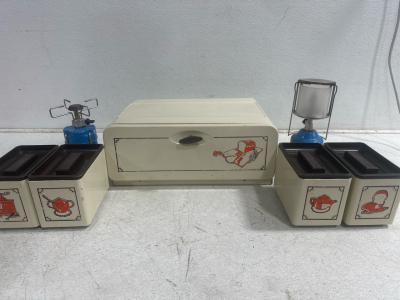 (1) Bread Box with Seperated Compartments, (1) Camping Gaz Gas Stove, and (1) Camping Gaz Gas Lantern