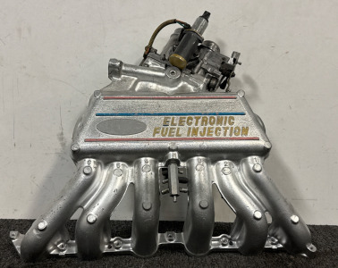 Upper Intake Manifold For A Ford F-Series Truck, Specifically Compatible With Models From 1987 To 1996 Featuring The 4.9L (300ci) Inline 6-Cylinder Engine With Electronic Fuel Injection.