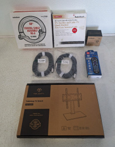 (1) Tabletop TV Stand, (2) 25-Foot HLS Audio Patch Cables, (1) RCA Universal Remote, (1) Echo Dot Mount, (1) 50-Foot Roll Of Radio Shack RG-8 Coaxial Cable Assy & (1) 50-Foot Roll Of Radio Shack RG-6/QS - 75-Ohm Quad Shielded Low Loss Antenna Cable