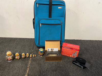 Teal Suitcase, Nesting Dolls, Reusable Therapeutic Heat Packs, A Silicone Body Scrubber & A Da Vinci Code Mini Crytex