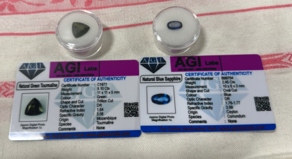 AGI Certified Gems (1) Natural Green Tourmaline (1) Natural Blue Sapphire.