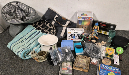 Collectable anime toys, Assortment of Computer, Phone, and Gaming Plug In Wires, Kids Crafts, (2) Boxes of Reading Glasses, Bluetooth Headphones, Fit Bit, Magazines, Garden Decor, (3) Landry Hampers, (30"X40") Rug, House Decor