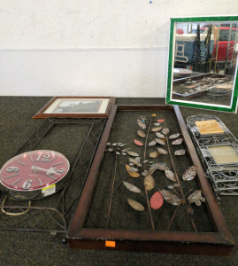Wall Decor Including; A Red Clock, Metal Art Work And a Medicine Cabinet