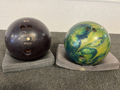 A Columbia 300 9P00341 Maroon Bowling Ball & A Xception Yellow and Green Marble Bowling Ball