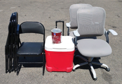 (4) Black Folding Chairs, (2) Gray Office Swivel Rolling Chairs, (1) 19"x 18"x 21" Red Igloo Cooler, & (1) Opened 3.66L Can of A-100 Extra White Exterior Acrylic Latex Paint