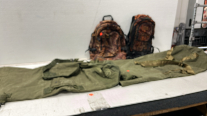 2 US Duffel Bags, 2 Fieldline Camo Backpacks, 1 Black and Blue Duffel Bag