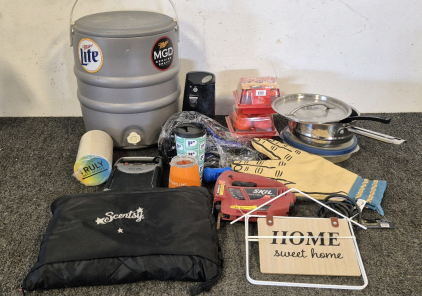 5Gal Miller Cooler, Truly Coasters, Go Ac PP150 AC(Unable to Test), Can Opener(Works), (2) Egglettes, Pots, Oven Mit, Skil Saw(Works), Home Decor, Poop Scoop, Non Spill Cups, Scentsy Garment Bag