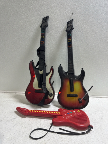 (2) Guitar Hero Guitars & (1) Radio Shack Guitar