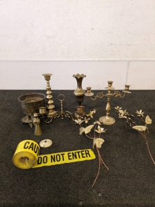 Brass candle holders and floral decor and caution tape Halloween decor