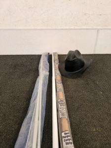 Dual purpose carpet strip and metal curtain rod and a cowboy hard hat