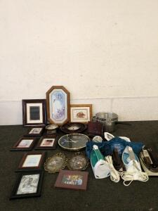 Collection of beautiful wall decor including clocks and picture frames plus antique irons and a vibrating heating pad