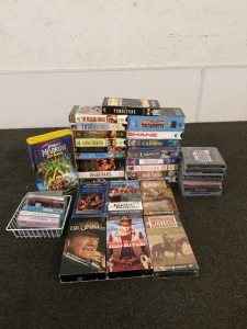 Collection of CDs and VHS tapes including Gone with the Wind and athe Perfect Storm
