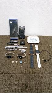Every Day Carry (4) assorted knives, a 400K volt stun gun, a display tray, (2) smart watches, (4) faux earrings, and more.