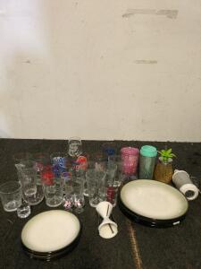 Assortment of glassware and plates including an egg whisk and a peeler