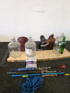 Bed Slats and catfish rods and a metal vase vintage glass bottles and a black light lamp