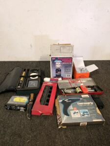 Assorted tools including fishing rod reel and fishing rod holder