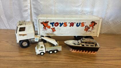 (1) Ertl Toys R Us Semi & Trailer (1) Tonka Bucket Truck (1) Funny Boat w/Feet