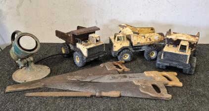 (3) Vintage Tonka Trucks, (3) Vintage Hand Saws, Vintage File, Vintage Homelite Searchlight, Often Used As a Rescue, Fire, or Emergency Floodlight (Works).