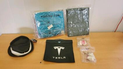 (1) Packaged Of Wishing Lights ,(2) Packages of Makeup sponges (1) Hat (1) Tesla Car Trash Bag(1) Opened Amazon Mystery Box