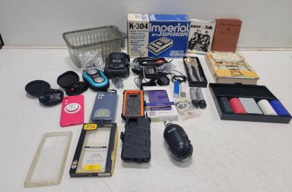 (1)Energizer Smart Outdoor 2K QHD Security Socket Camera (1)Imperial Cassette Recorder (2)Fitbit Versa 2 Smartwatch Charging Bases (2) Black &Decker VersaPak Batteries (7) Phone Cases (2)Portable Chargers,(2)Portable Speakers and More