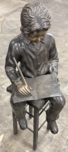 Boy Writing On Stool Bronze Statue